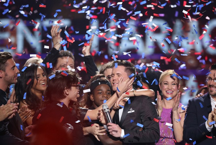 Trent Harmon, center, winner of "American Idol" The Farewell Season celebrates with fellow contestants during the season finale at the Dolby Theatre on Thursday in Los Angeles. The Associated Press